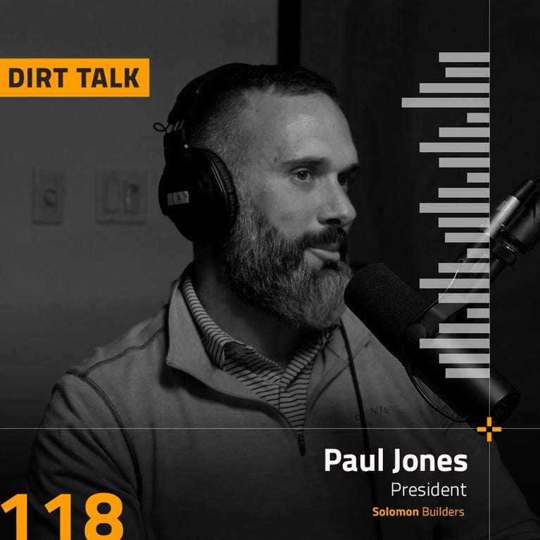 Paul Jones in headphones with the dirt talk logo behind him