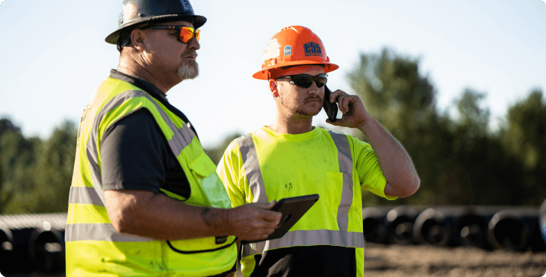 Excavator Operator and Manager Communicating