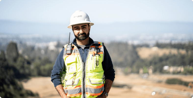 Construction worker standing on a hill