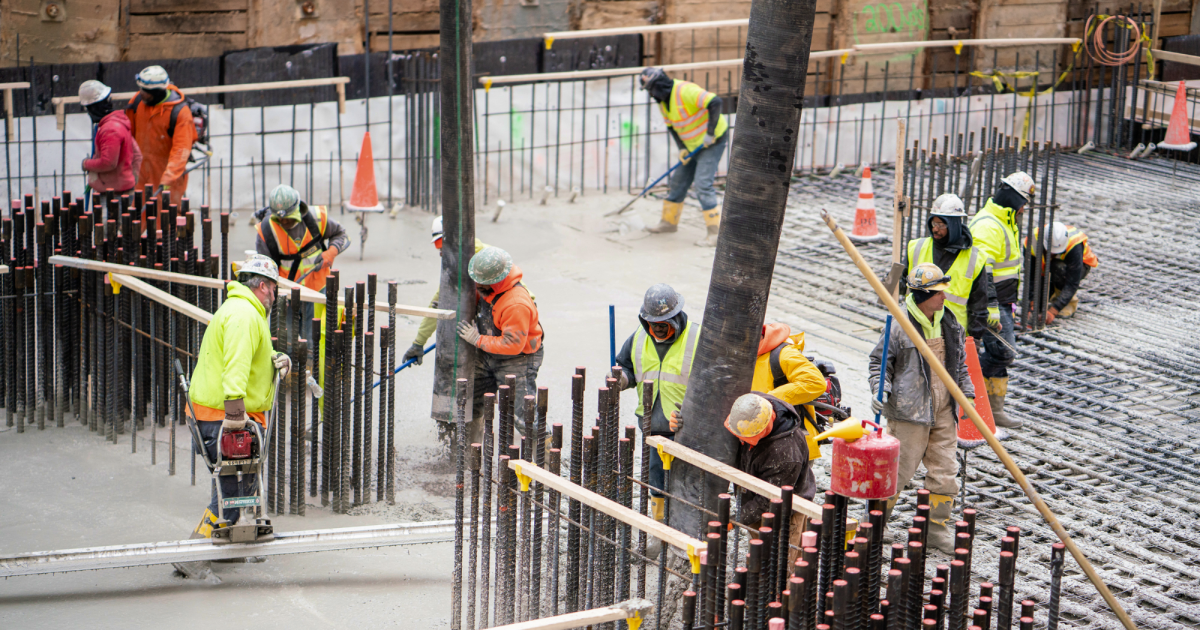 Construction crew setting rebar