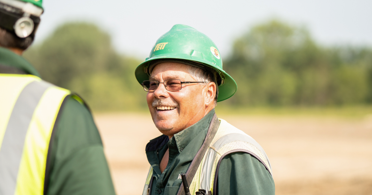 A construction leader smiling