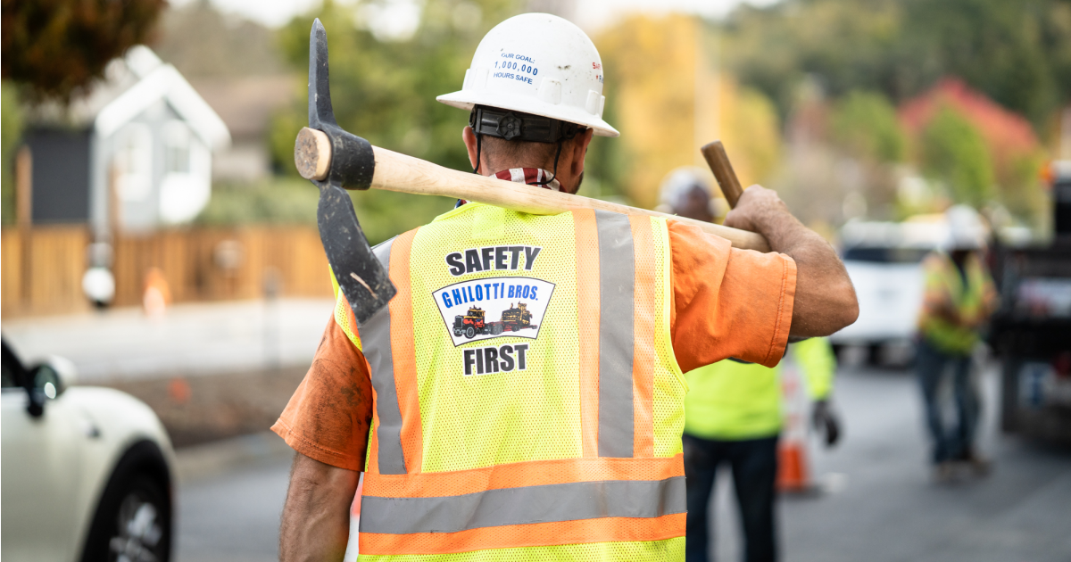 Construction worker carrying a hand tool