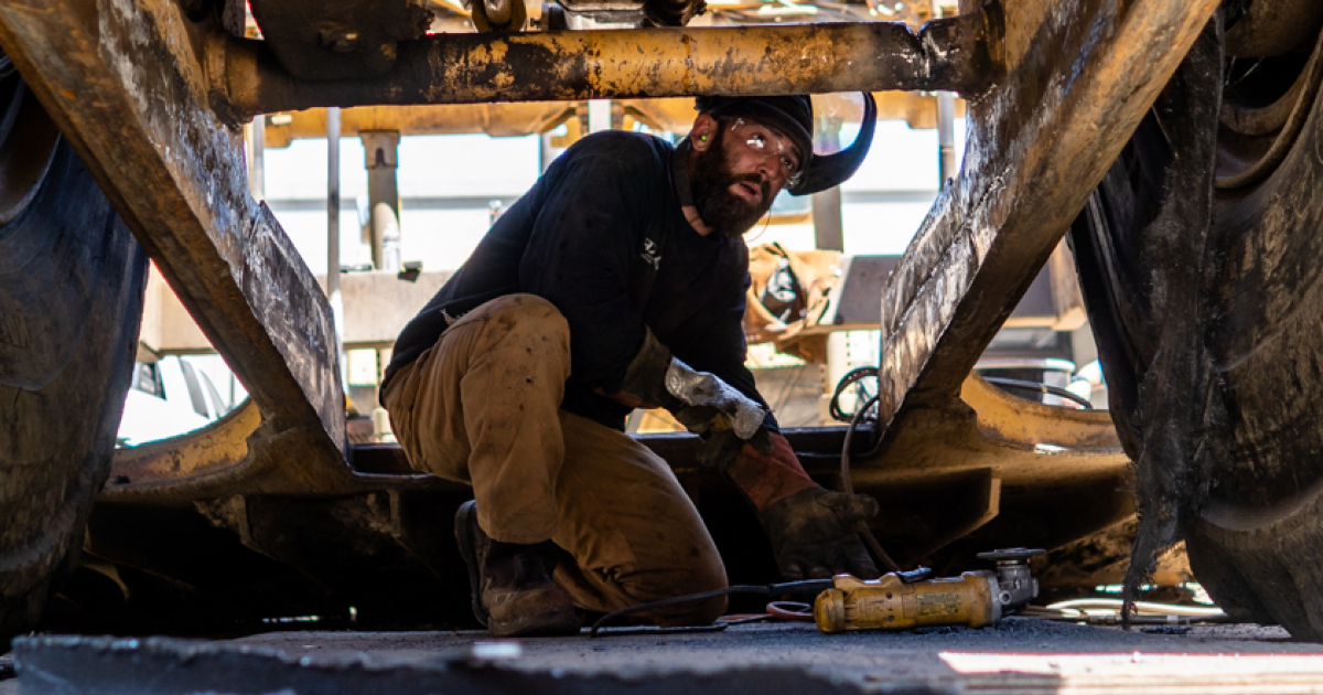 Heavy equipment mechanic working on machine