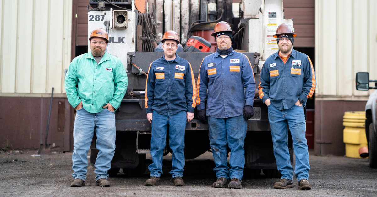four men on a jobsite