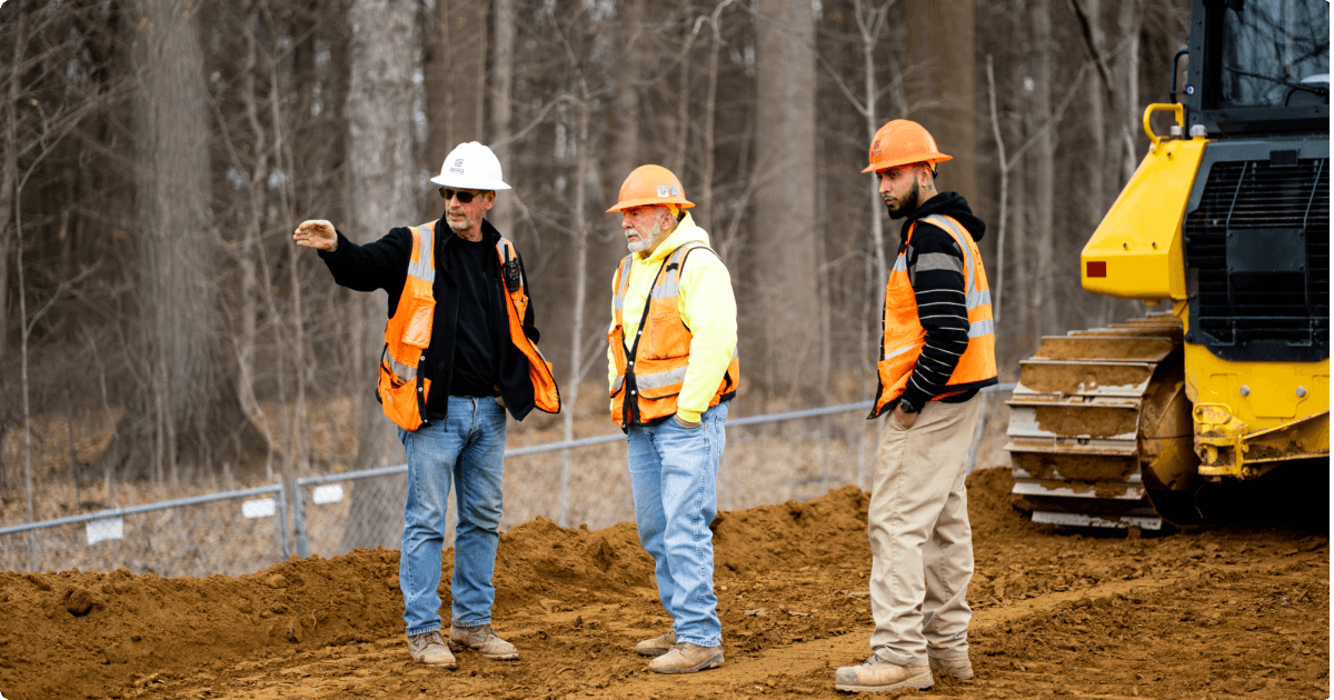 Three workers on a grade