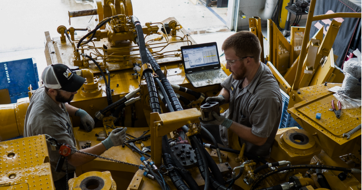 Mechanics working on heavy equipment