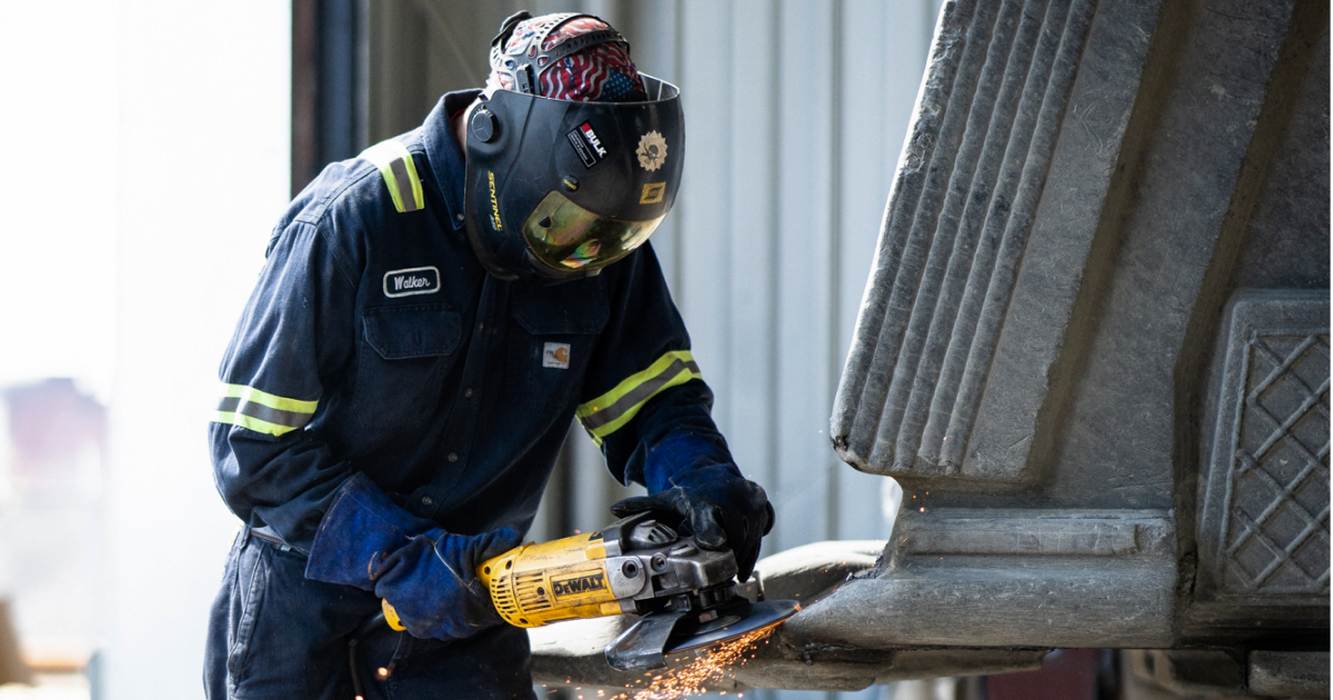 Worker using a power sander