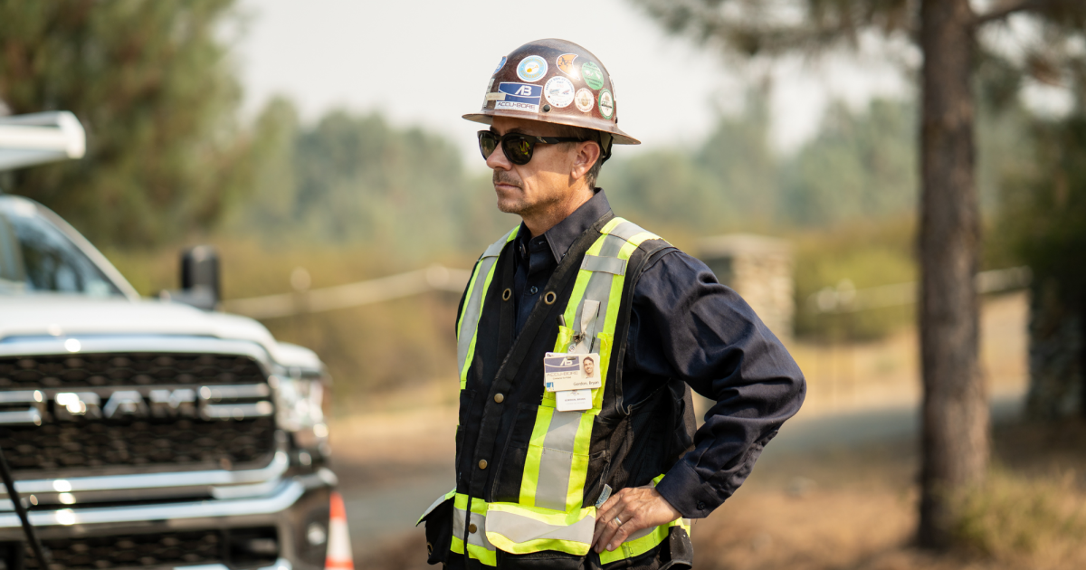 Dirt World worker in front of a pickup truck