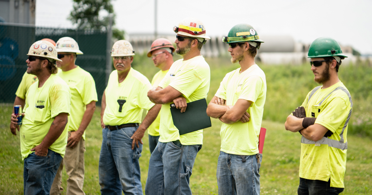 People wearing hi-viz shirts standing in a line